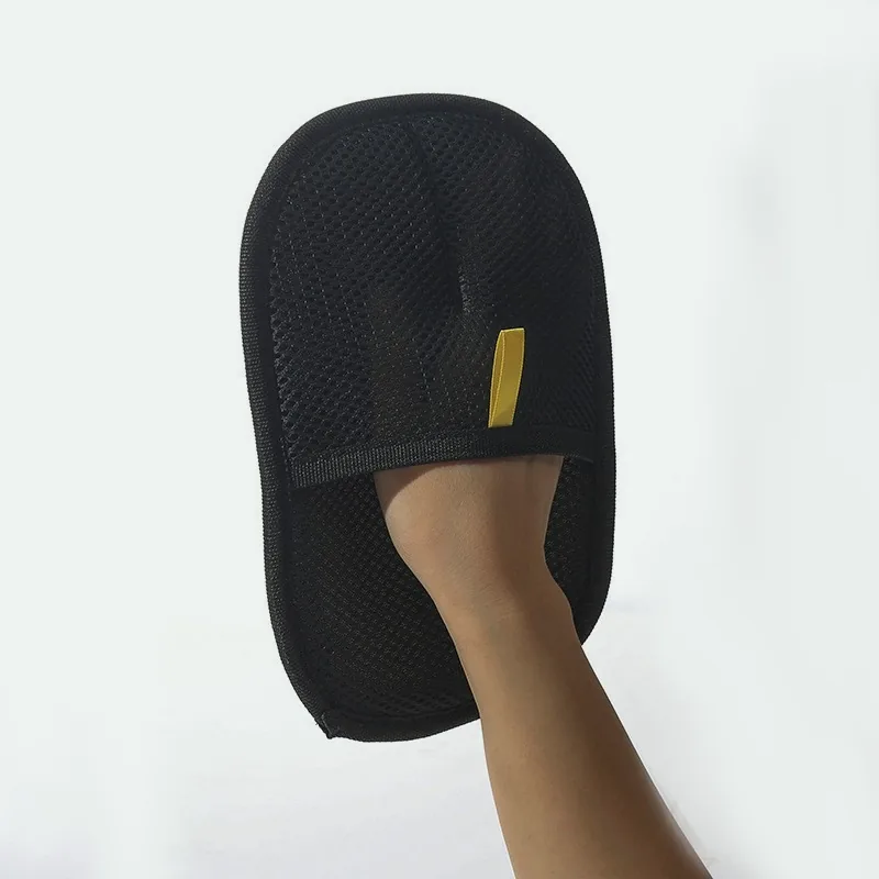 Hand inside the black mesh pet hair mitt
