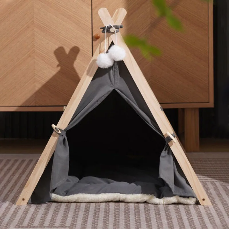 Grey canvas pet teepee on a pine frame with tied-back curtains, white pompoms and a cushion inside